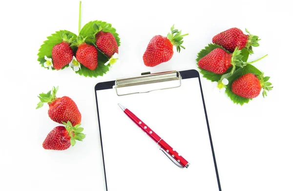 Strawberry and notebook on a white background