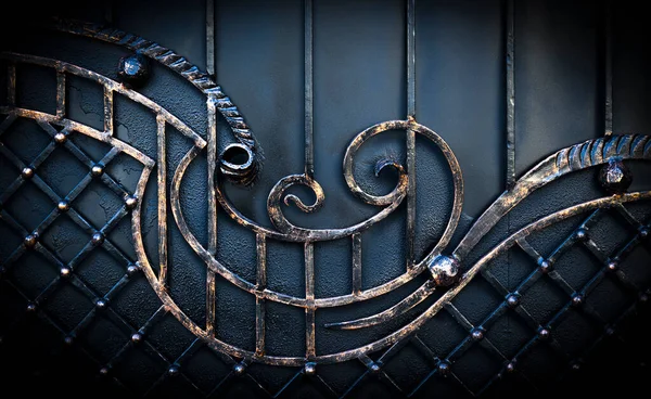 Casting ornament on a wrought cast iron fence in a park