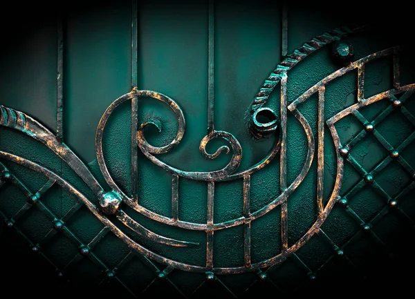 Casting ornament on a wrought cast iron fence in a park