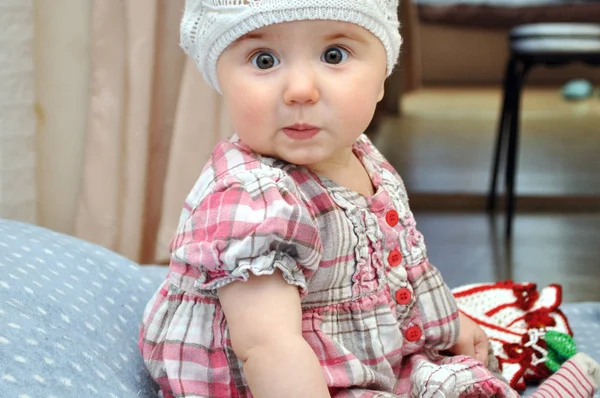 One year old Child portrait of surprised girl