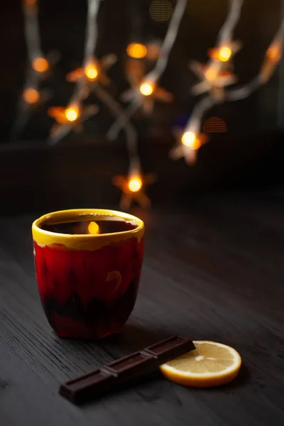 Bir fincan çay ile arka plan üzerinde Noel ışıkları — Stok fotoğraf