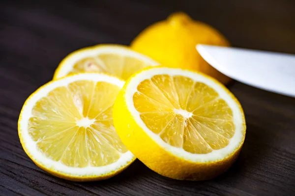 Нарезанный лимон на темном фоне вблизи — стоковое фото