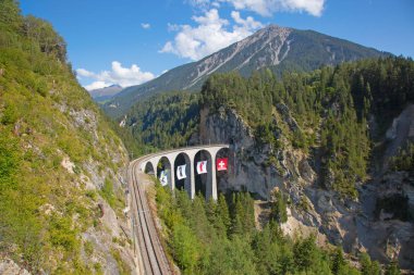 Famous Landwasser viaduct nearby Filisur town in the swiss alps clipart