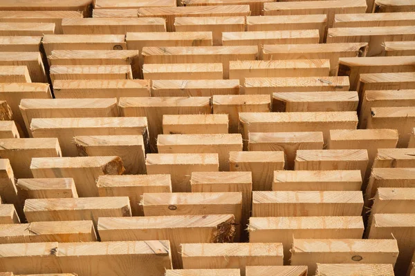 Stack of new wooden studs at the lumber yard