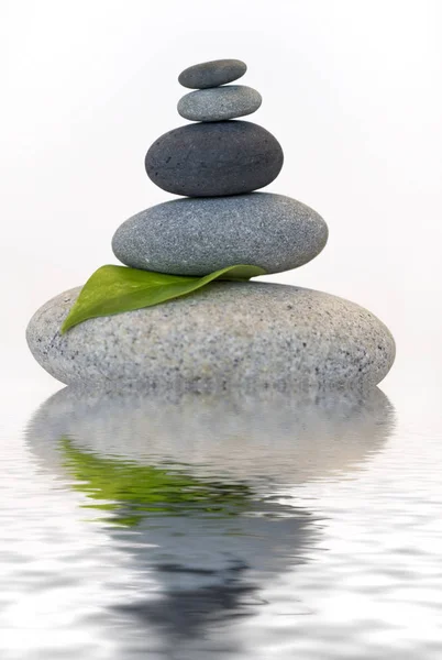 Balanced Pebble And Leaf Across Water — 스톡 사진
