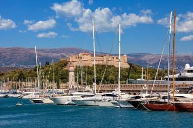 White luxury yachts moored in port of Antibes - -famous city on French Riviera. clipart