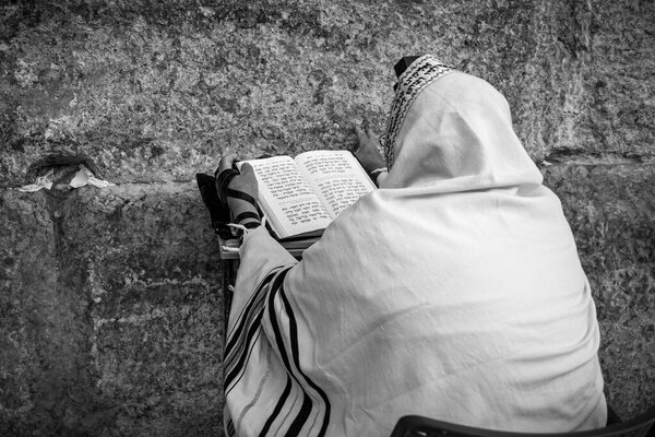 Prayer at Western Wall on Tisha B'Av - annual fast day in Judaism, commemorates anniversary of number of disasters in Jewish history and destruction of the First and Second Temples in Jerusalem.