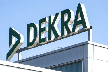 Mağaza önünde mavi gökyüzü arka plan - Dekra Wetzlar - Almanya-25 Mart 2018 - Dekra logosuna otomotiv teknik muayene zinciridir