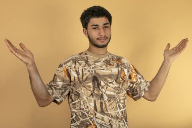 Genç adam kaldırsın kadar bej renkli arka plan üzerinde