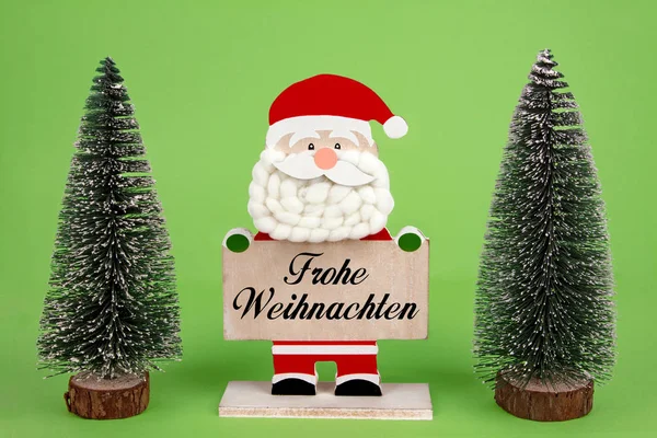 Decoratieve Houten Kerstman Houden Een Bord Met Duitse Tekst Frohe — Stockfoto