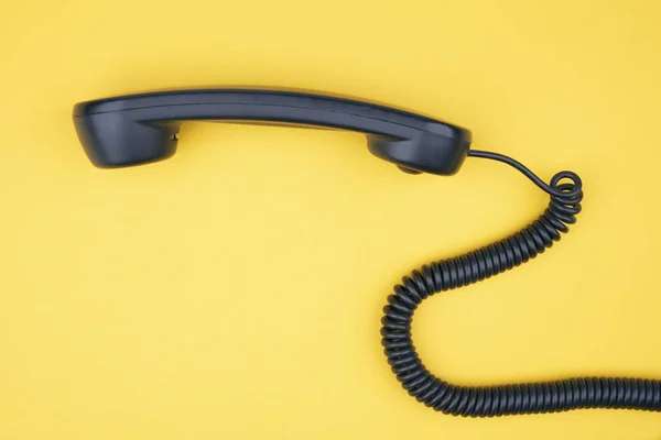 Black Phone Receiver Yellow Background — Stock Photo, Image