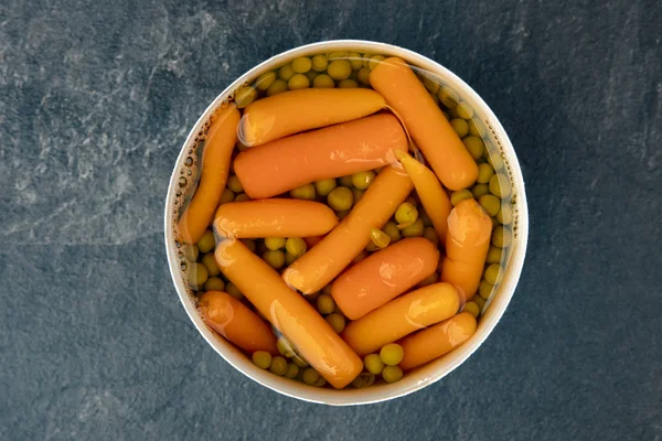 Peas and carrots in can — Stock Photo, Image