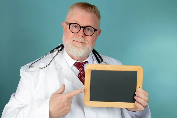 Doctor holding blank chalkboard — Stock Photo, Image