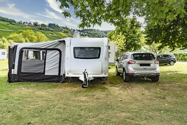 Caravan with car on campsite in the moselle valley in Germany