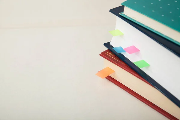 Stack of books with colored memory notes and copy space