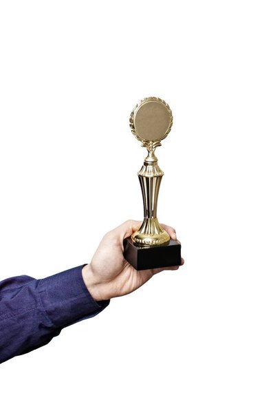 Hand in blue shirt sleeve holding golden laurel wreath trophy isolated on white