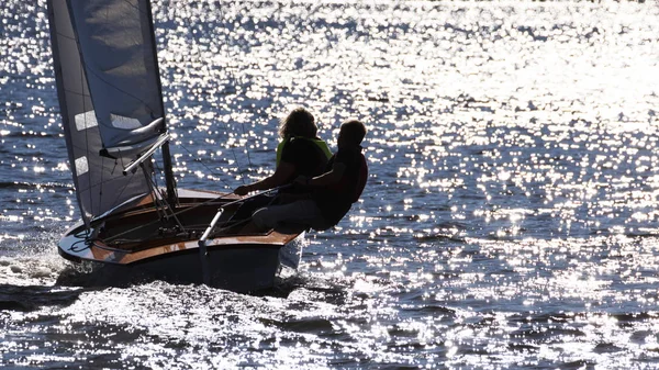 couple sailing against backlight