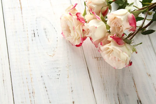 Rosas brancas em um fundo de madeira — Fotografia de Stock