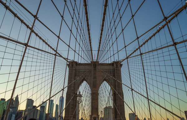 Brooklyn bridge in new york with a geometric perspective at sunset.