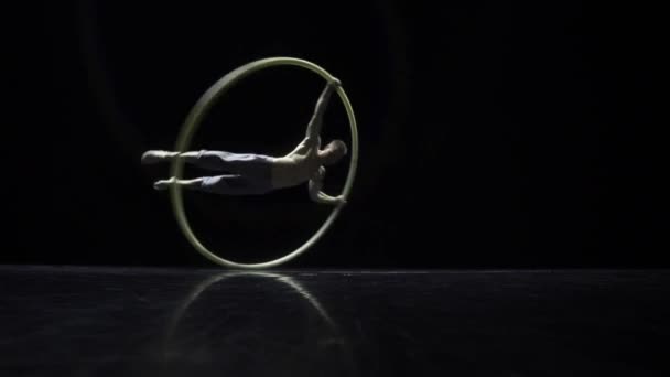 Artista intérprete de circo en una rueda de circo en el teatro sobre fondo negro — Vídeos de Stock