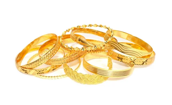 Bracciali in oro su sfondo bianco — Foto Stock