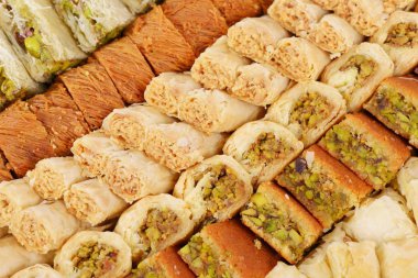 Arabic sweets with pistachios, walnuts and cashew clipart