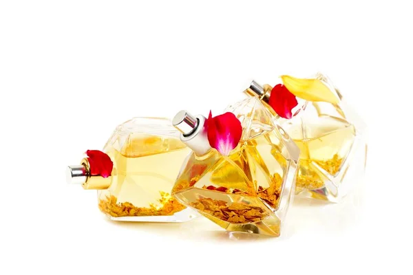 Perfumes com flocos dourados no interior, sobre branco — Fotografia de Stock