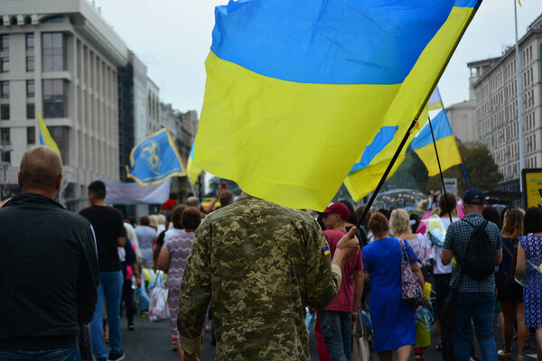 Kyiv, Ukraine - August 24, 2020: Veterans of the Russian-Ukrainian war, military, volunteers, activists, families of those killed in the war, and during the Revolution of Dignity walk along Khreshchatyk Street to applause from Ukrainians.