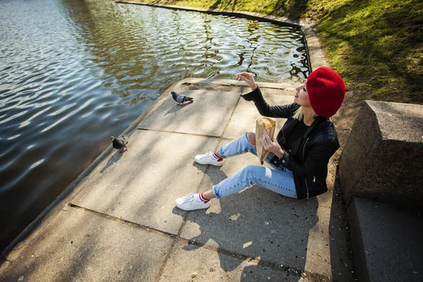 Happy woman in french beret hat in park outdoors