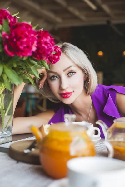 Happy Young Woman in Restaurant