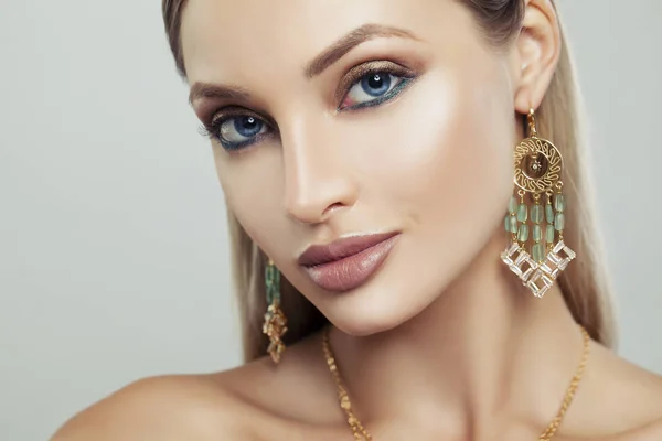 Attractive Woman with Gold Earrings with Green Gem, Fashion Portrait