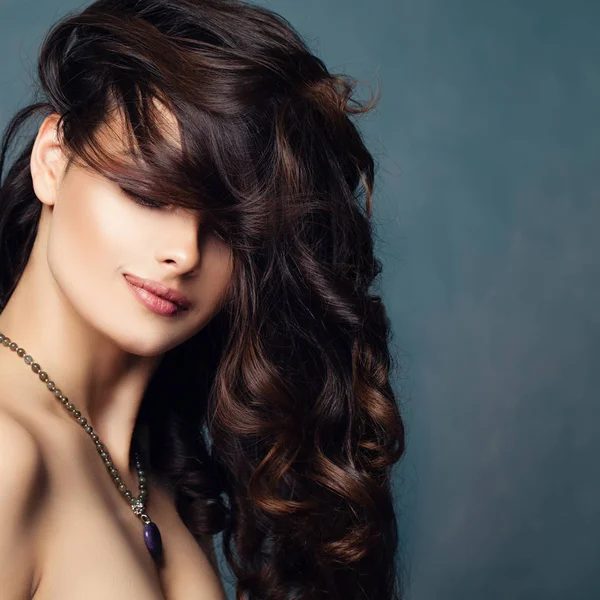 Brunette lady with permed hair. Gorgeous woman with curly hairstyle