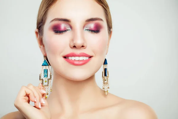 Perfect woman face closeup. Young beautiful female model with makeup smiling