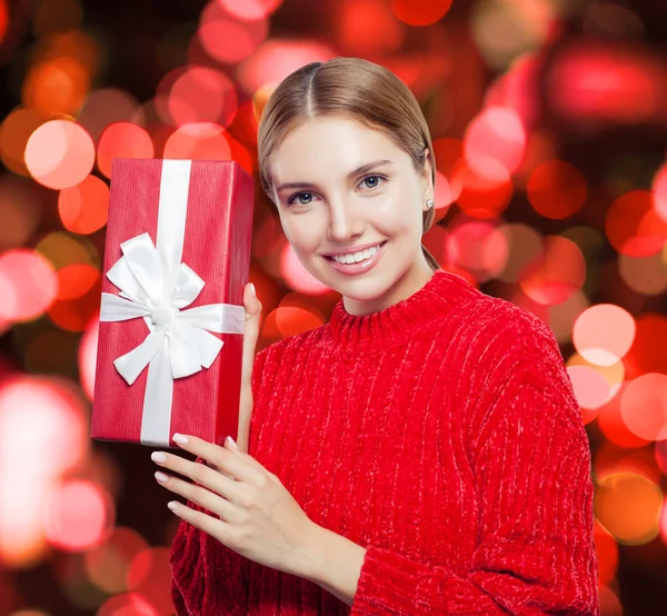 Smiling Woman Sweater Red Gift Box Bokeh Background — Stock Photo, Image