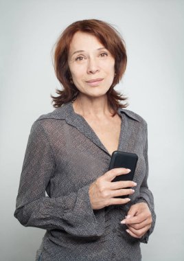 Beyaz arka plan üzerinde smartphone ile Olgun kadın