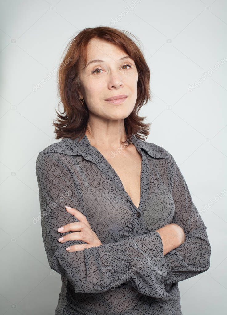 Mature woman with crossed arms, portrait