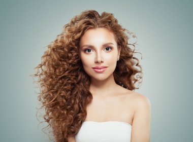 Gri arka plan üzerinde uzun sağlıklı saç modeli kadınla genç güzel model