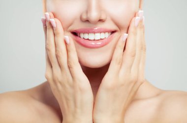 Closeup female smile and manicured hand. French manicure, white teeth and pink glossy lips makeup clipart
