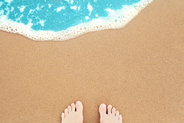 Feet on sea sand and surf. Vacation on ocean beach — Stock Photo, Image