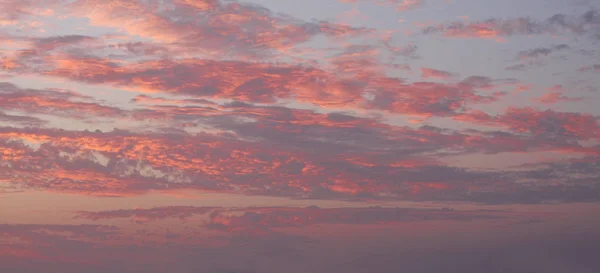 Blue sky red clouds background. Beautiful landscape with clouds