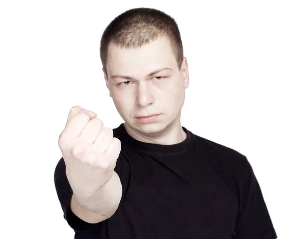 Молодий сердитий чоловік показує Кулак. На білому тлі — стокове фото