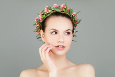 Young woman with clear skin looking aside.
