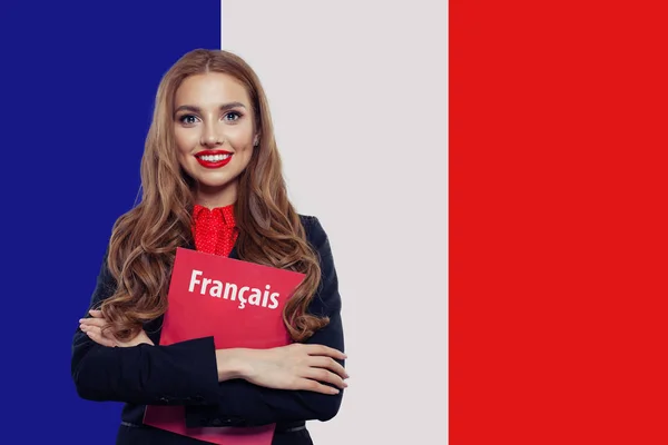 Potret wanita cantik tersenyum dengan buku tentang bendera Perancis — Stok Foto