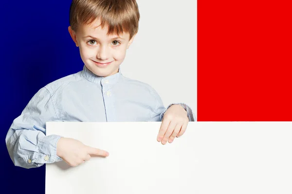 Happy child boy holding white empty banner on the Franch flag — Stock Photo, Image