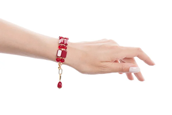 Bracelet with red coral on female hand isolated on white background — Stock Photo, Image