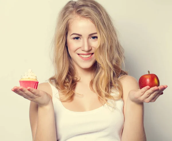 健康的で不健康な食べ物で笑顔の美しい女性. — ストック写真