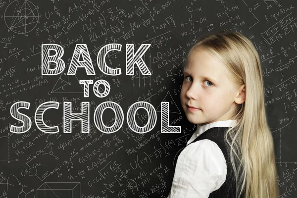 School girl and chalkboard with math formulas. Back to school