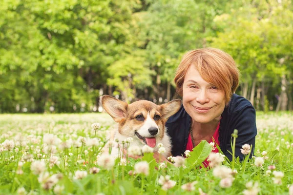 Mulher muito mais velha com seu cão no parque em um dia ensolarado — Fotografia de Stock