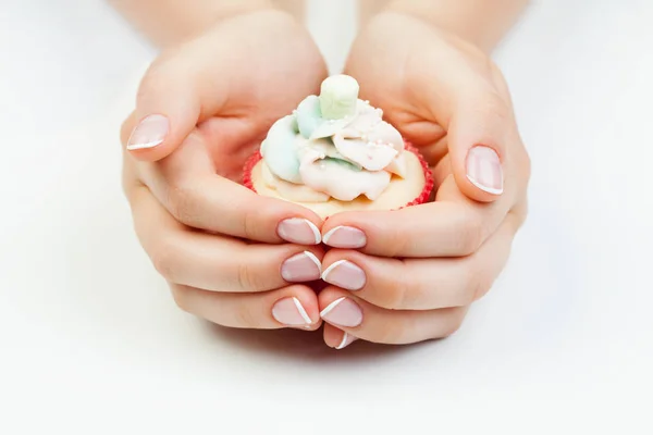 French manicure. Manicured nails and cupcake on white background — Stock Photo, Image