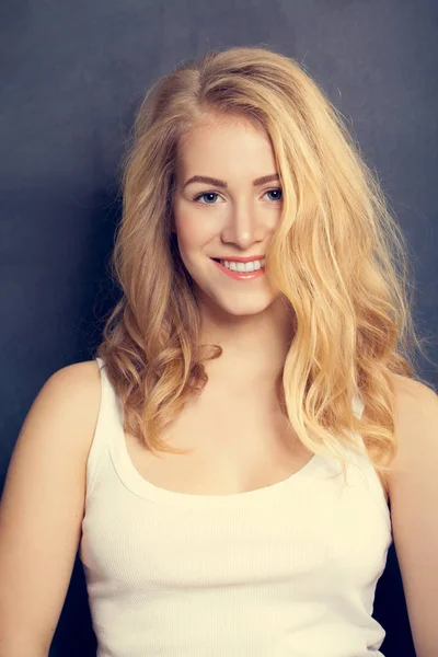 Smiling Blonde Woman on dark  background. Makeup and Curly Hairs — Stock Photo, Image